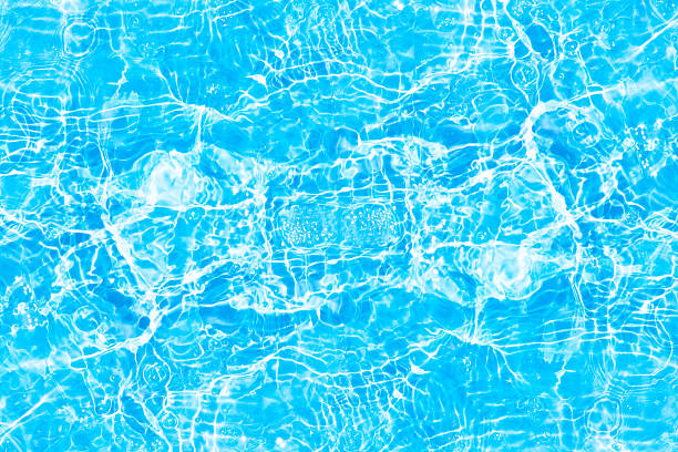 istock Blue water with ripples on the surface. Defocus blurred transparent blue colored clear calm water surface texture with splashes and bubbles. Water waves with shining pattern texture background. 2245212218
