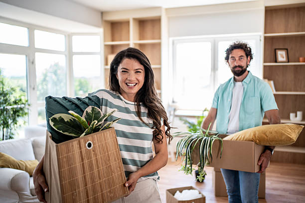 istock Happy couple moving into new apartment with boxes 2245212255
