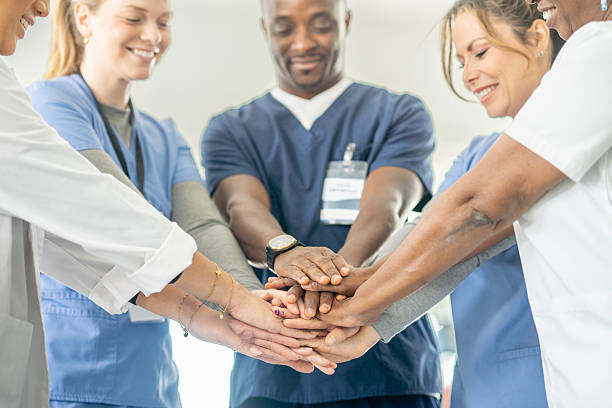 istock Diverse Medical Team Joins Hands In Unity For Collaboration And Care 2245213199