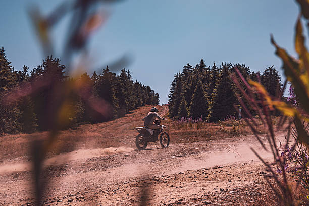 istock A motocross rider's adventure on a sunlit trail 2245214181