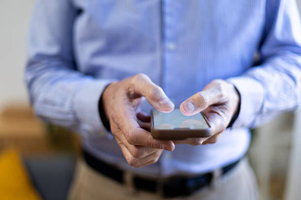 istock Senior man typing on smartphone connecting with technology 2245214407