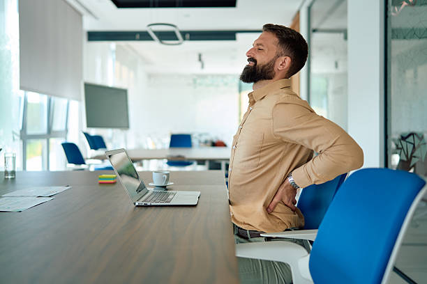 istock Businessman suffering back pain working in office 2245215354