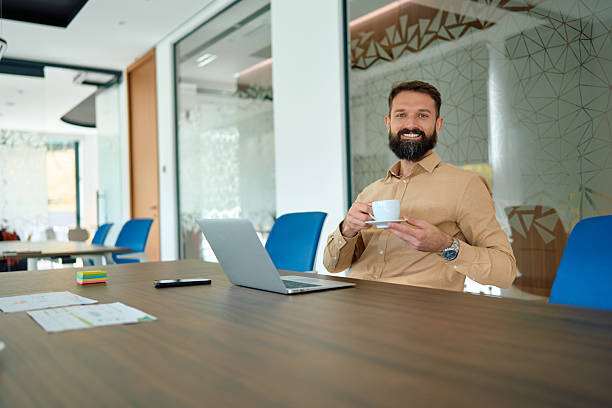 istock Businessman having coffee break in modern office 2245215358