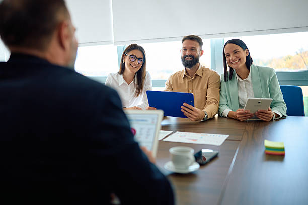 istock Smiling business people having meeting in a modern office 2245215389