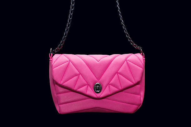 istock Pink textile women's handbag with a strap on a black background 2245215675