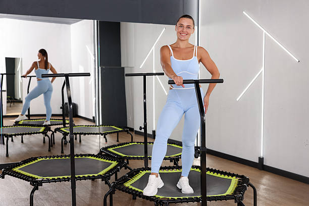 istock Smiling woman on mini exercise trampoline in fitness studio 2245218169