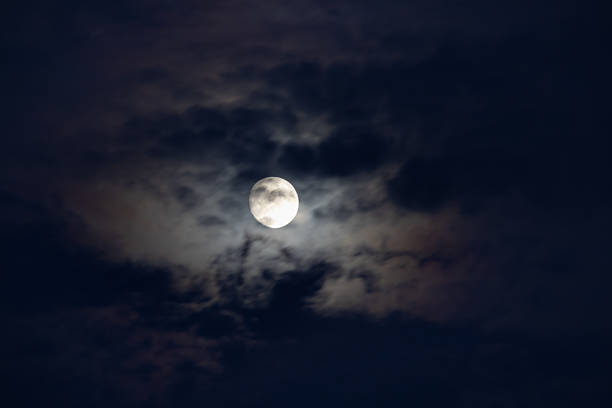 istock mystical night, full moon glowing brightly through dark, wispy clouds. a dramatic, mysterious, and ominous atmosphere perfect for halloween, horror, or fantasy themes 2245218900