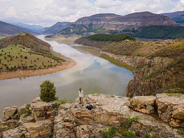 istock Man Birdwatching From Scenic High Viewpoint To Fjord 2245220280