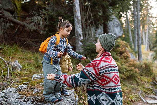 istock Family enjoying forest walk, exploring, playing and jumping around. 2245220668