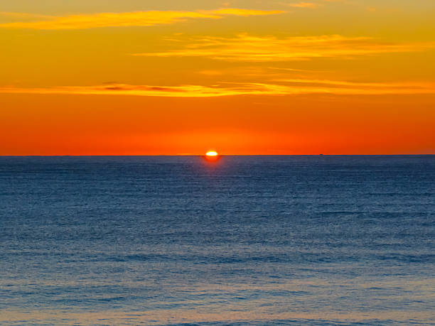 istock Ocean Sunrise Under Clear Skies with Orange Horizon 2245222138