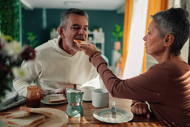 istock Senior couple sharing toast with jam during breakfast 2245222910