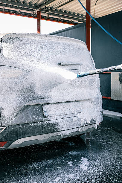 istock Car being washed with foam at a car wash 2245224623