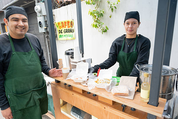 istock Vendors Serve Breakfast and Beverages at Rustic Cart 2245225869
