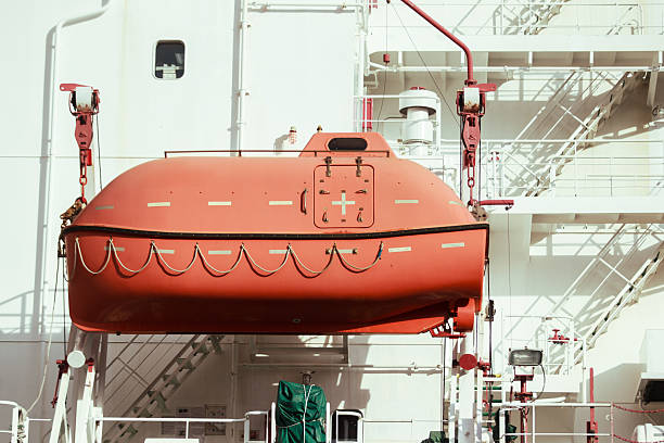 Lifeboat capsule installed on a large ocean vessel, designed for emergency crew evacuation, showcasing marine safety equipment, maritime technology, and essential life-saving systems at sea.