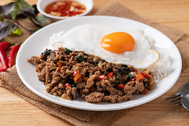 istock Thai food, Stir fried holy basil with minced pork with cooked rice and fried egg on top 2245231105