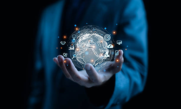 istock Businessman holding a digital holographic globe with technology icons representing global business, innovation, data analytics, and network connection. Perfect for fintech, AI. 2245234225