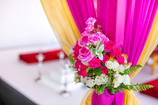 White chairs at the wedding ceremony with rose petals.