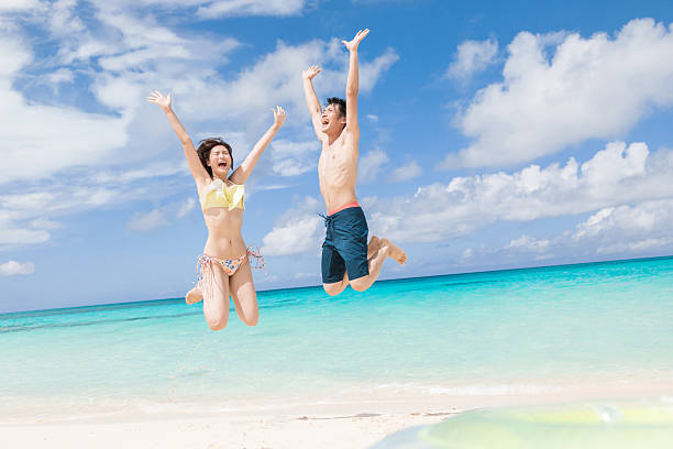 istock Asian couple having fun on the beach at a resort 2245239939