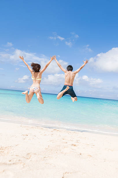 istock Asian couple having fun on the beach at a resort 2245240099