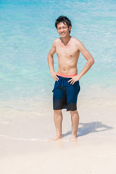 Asian man having fun on the beach at a resort