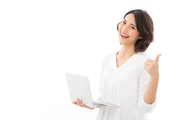 istock Asian woman giving a thumbs up sign while using a computer 2245243670