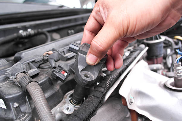 istock Mechanic hand replacing ignition coil on car engine, concept of engine repair, spark plug maintenance, automotive service 2245245890