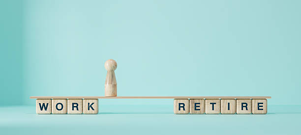 istock Balancing work and retirement concept with red and blue wooden blocks spelling WORK and RETIRE on a seesaw. Life planning, career transition, and financial future. 2245250241