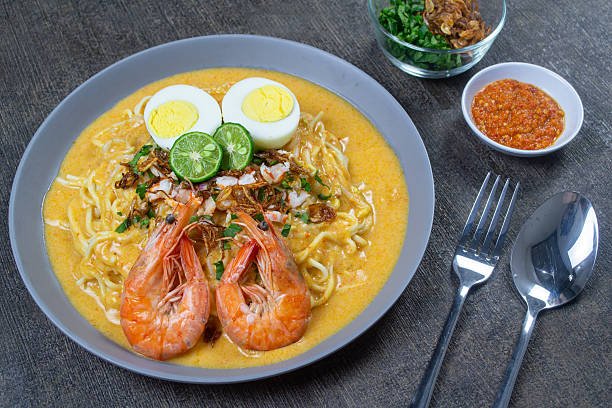 istock mie celor palembang served on a gray plate, a noodle dish from Palembang, South Sumatra, that uses a thick, savory broth made from coconut milk and shrimp stock. indonesia food 2245250829