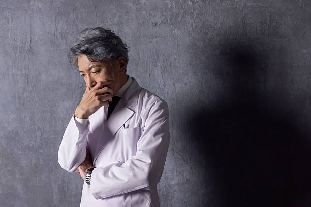Asian middle-aged man wearing a white coat