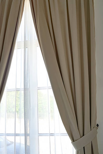 istock Elegant Window with Sheer and Beige Curtains 2245259166