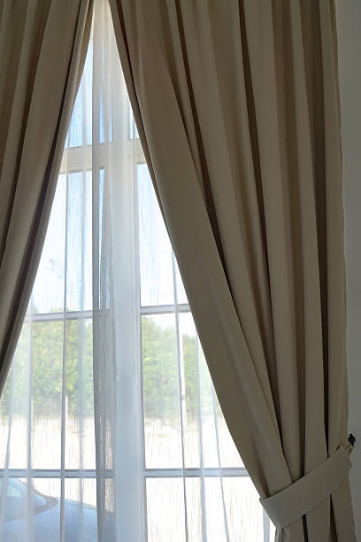 istock Elegant Window with Sheer and Beige Curtains 2245259173