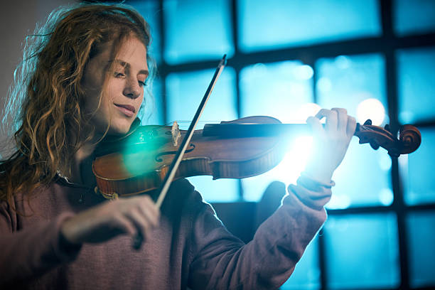 istock Carefree woman playing violin. 2245261124