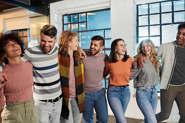 istock Group of cheerful friends having fun while walking embraced. 2245261473