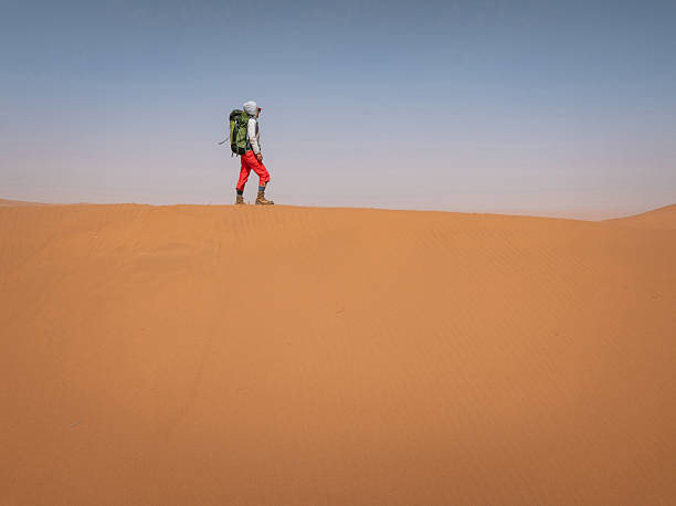 istock Woman backpacking in the desert 2245263388