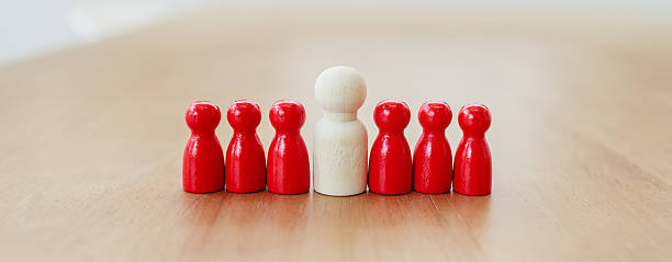 istock Leadership recruitment concept with white figure standing out among red figures symbolizing team guidance and selection process 2245264335