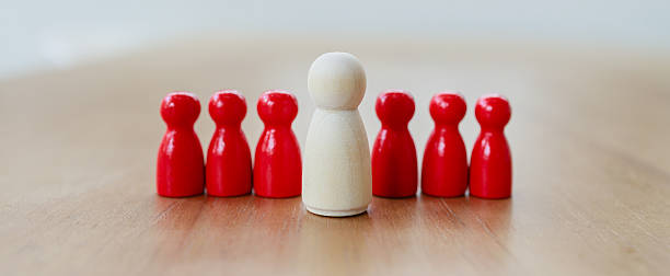 istock Leadership recruitment concept with white figure standing out among red figures symbolizing team selection and guidance in business 2245264337