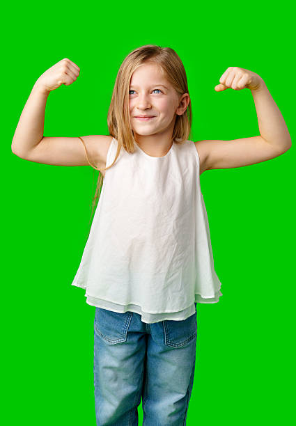 istock A confident girl flexing her muscles in a green background 2245264512
