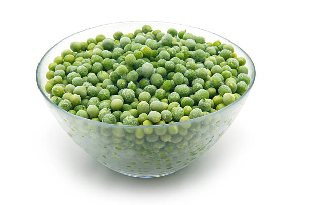 istock Green frozen peas. In a glass dish 2245266399