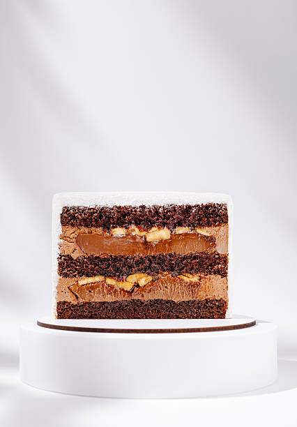 istock Delicious chocolate cake with layers of cream and fruit on display 2245266529