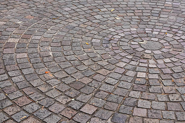 istock A stone-paved path in autumn with falling leaves. 2245266562