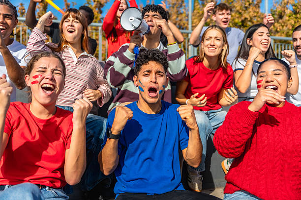 istock Young adults cheering at stadium sporting event 2245266925