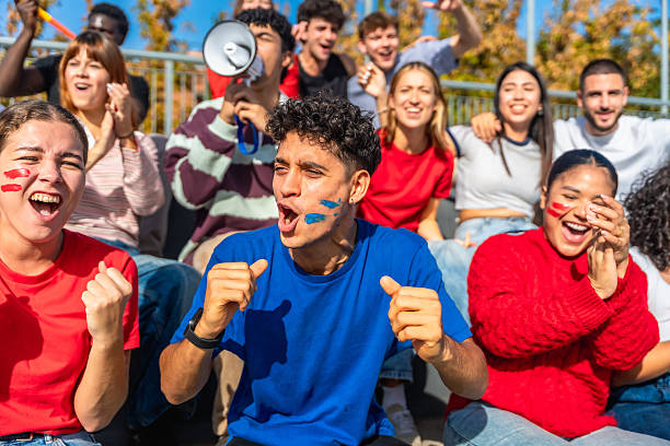 istock Young people cheering and celebrating team victory at a stadium 2245266928