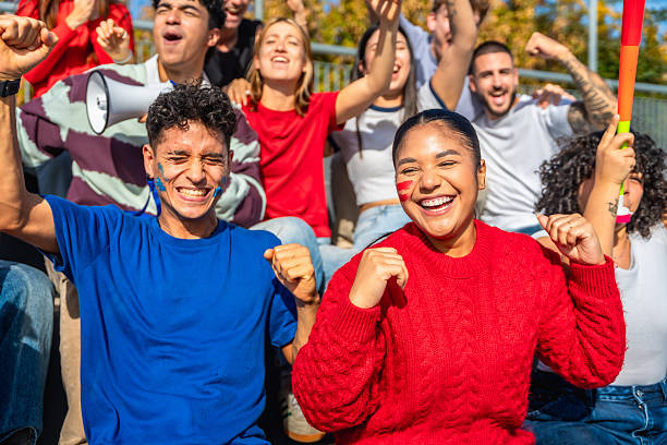 istock Diverse group of friends cheering at sport event 2245266953