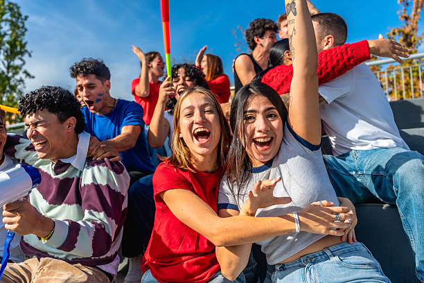 istock Friends cheering happily at a sports event 2245267033