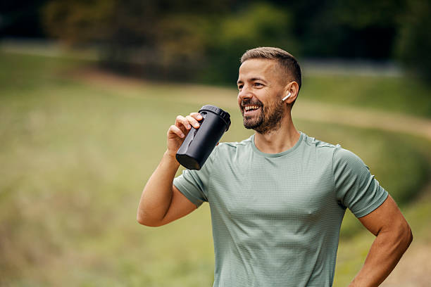 istock Man drinking protein shake after intense outdoor workout 2245267063