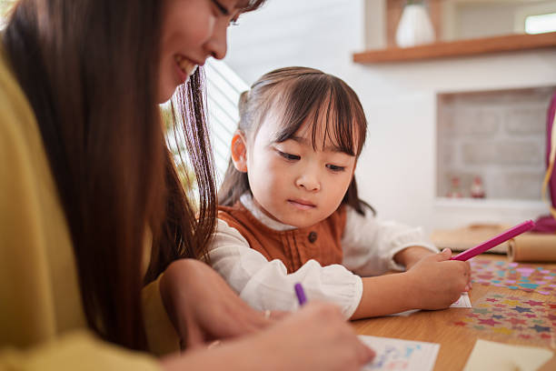 istock Mother and Daughter Making Christmas Crafts Together 2245267214