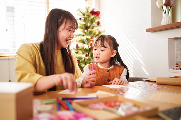 istock Mother and Daughter Making Christmas Crafts Together 2245267320