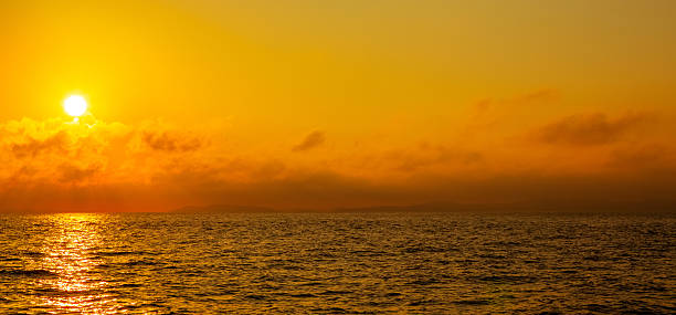 istock Seascape scenery.  Red and orange light over the sea at sunset. 2245268392