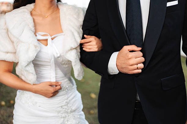 Bride and groom walking arm in arm, celebrating their loving marriage