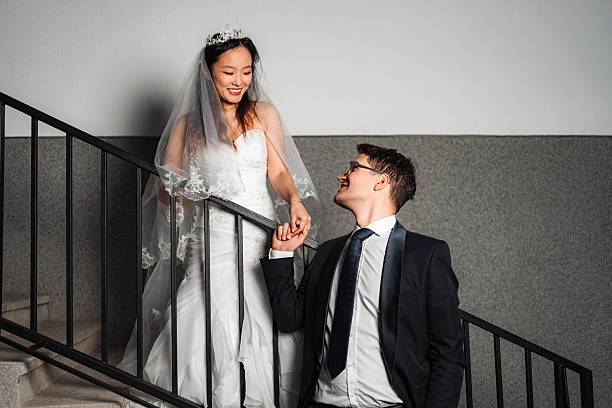 Bride and groom happily descending stairs after their wedding ceremony